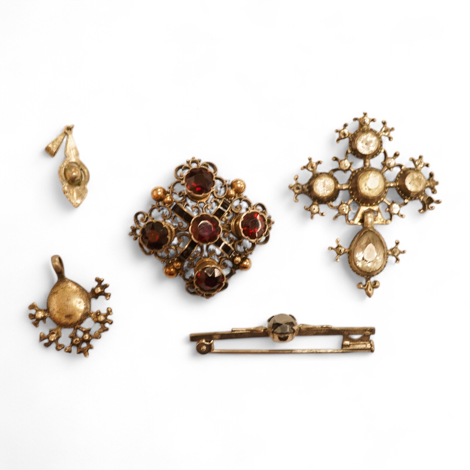 A late 19th/early 20th century Viennese pierced white metal, enamel and garnet cluster set brooch, 34mm, together with four other items of paste set jewellery.